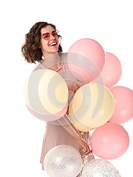 Beautiful young woman with air balloons on white background