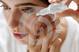 Beautiful Young Woman Applying Eyedrops In Eyes. Visual Concept