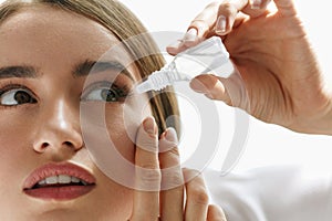 Beautiful Young Woman Applying Eyedrops In Eyes. Visual Concept