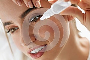 Beautiful Young Woman Applying Eyedrops In Eyes. Visual Concept
