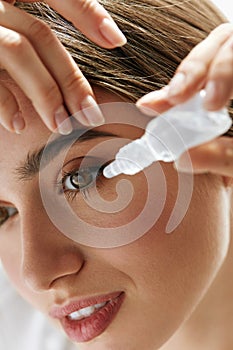 Beautiful Young Woman Applying Eyedrops In Eyes. Visual Concept