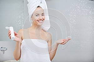 Beautiful Young Woman applying facial moisturizing cream.Skincare concept