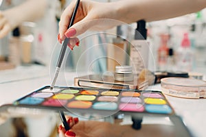 Beautiful young woman applying makeup beauty visage brush