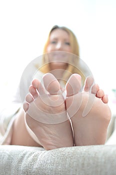 Beautiful young woman applying nail paint