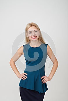 Beautiful young woman with arms akimbo