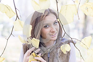 Beautiful young woman among autumn leaves, autumn lifestyle concept.