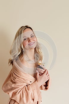 Beautiful young woman in bath robe. Head. Blonde. Drinking coffee.  Morning at home