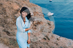 Beautiful young woman at beach looking at camera