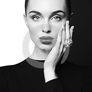 Beautiful young woman with big ring pose in studio