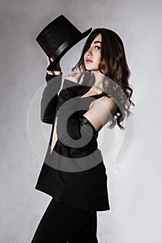 Beautiful young woman in a black hat and a black jacket