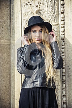 Beautiful young woman in black hat