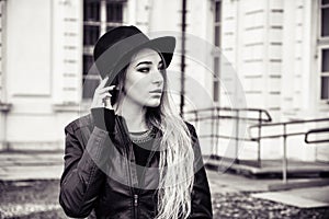 Beautiful young woman in black hat