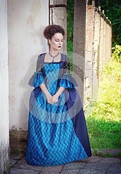 Beautiful young woman in blue medieval dress