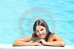 Beautiful young woman in blue swimming pool