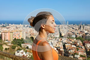 Beautiful young woman breathing with closed eyes after excercise and enjoying the silence quiet tranquil spiritual reflection