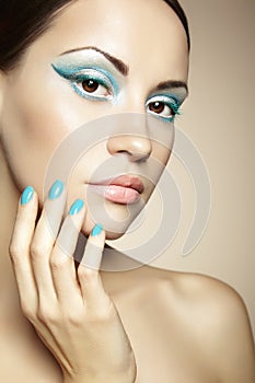 Beautiful young woman with bright make-up and mani