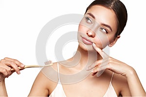 Beautiful young woman brushing her teeth