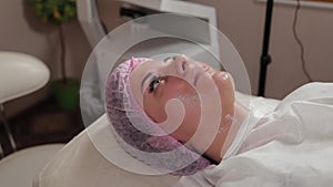 Beautiful young woman in a cap at the beauty parlor.