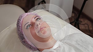 Beautiful young woman in a cap at the beauty parlor.