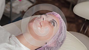 Beautiful young woman in a cap at the beauty parlor.