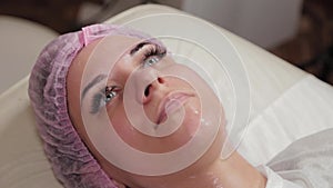 Beautiful young woman in a cap at the beauty parlor.