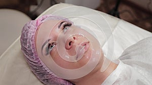 Beautiful young woman in a cap at the beauty parlor.