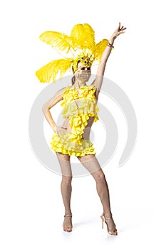 Beautiful young woman in carnival, stylish masquerade costume with feathers dancing on white studio background.