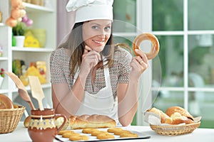 Beautiful young woman in chefs hat baking