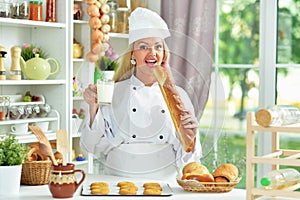 Portrait of beautiful young woman in chefs hat baking at home