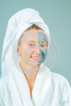 Beautiful young woman with clay facial mask. Skincare and beauty Concept