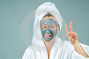 Beautiful young woman with clay facial mask. Skincare and beauty Concept