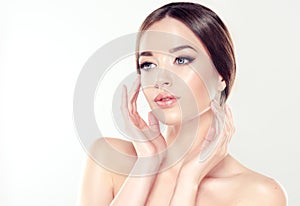 Beautiful young woman with clean fresh skin. Cosmetic and cosmetology. photo