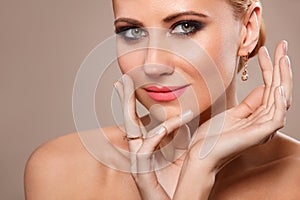 Beautiful Young Woman with Clean Fresh Skin touch own face . Facial treatment . Cosmetology, Beauty and spa .