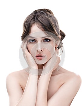 Beautiful young woman with clean healthy skin touch her face