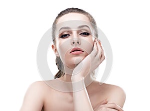 Beautiful young woman with clean healthy skin touch her face