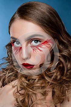 Beautiful young woman with clean perfect skin. Portrait of beauty model with bright red make up and long eyelashes