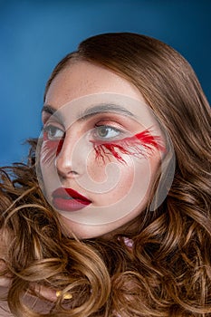 Beautiful young woman with clean perfect skin. Portrait of beauty model with bright red make up and long eyelashes