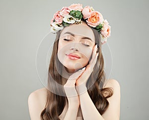 Beautiful young woman with clear skin portrait. Pretty girl with long curly hair and flowers.