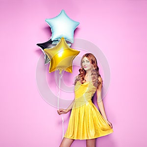 Beautiful young woman with colorful balloons