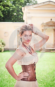 Beautiful young woman in corset and shirt