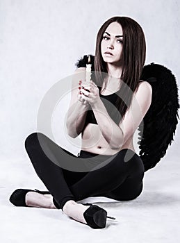 Beautiful young woman in a costume of the dark angel