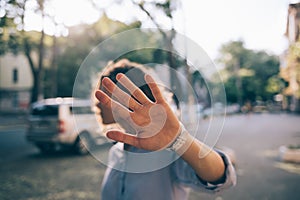 Beautiful young woman covering face with her palm