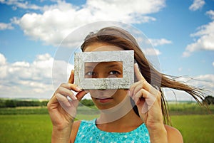 A beautiful young woman creates a frame