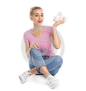 Beautiful young woman with cute rabbit on white background