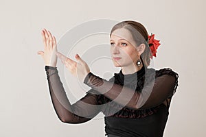 Beautiful young woman dancing flamenco in a black dress