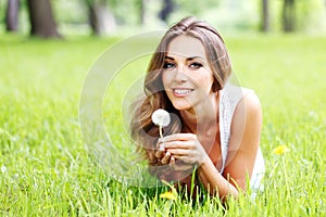 Beautiful young woman with dandelion