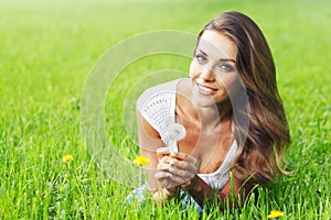 Beautiful young woman with dandelion