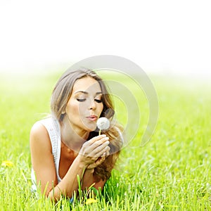 Beautiful young woman with dandelion