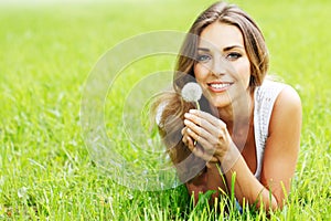 Beautiful young woman with dandelion
