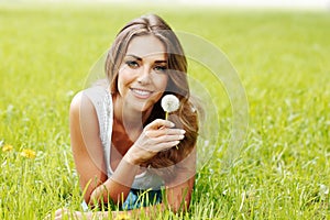 Beautiful young woman with dandelion